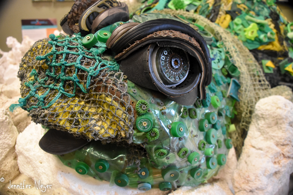 Volunteers create art from beach refuse.