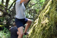 Kathy climbs up a rock.