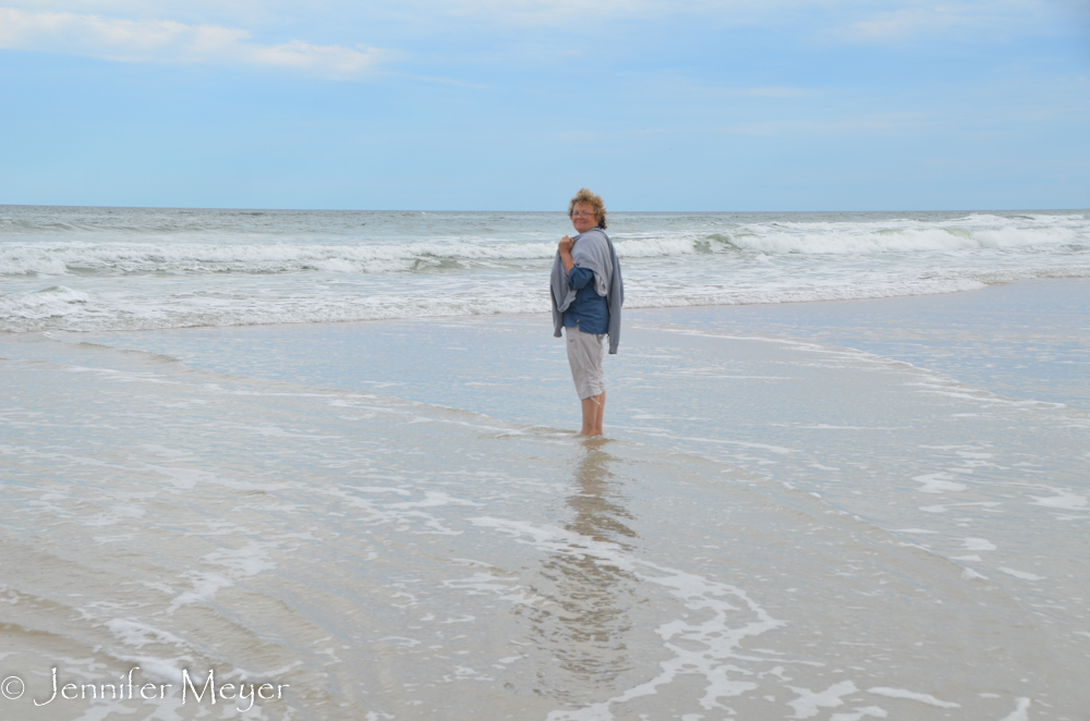 Feeling the cold water on her feet.