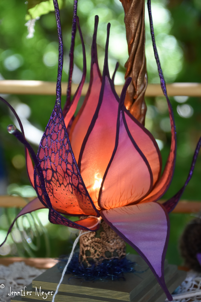 The artist makes incredible painted silk flower lamps.