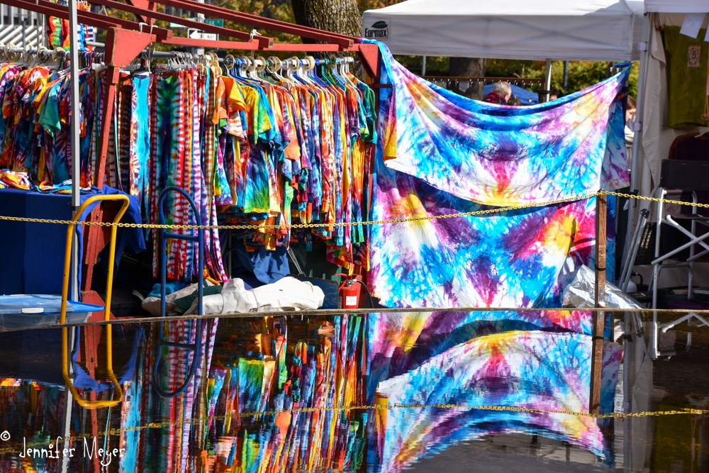 Tie-dye reflected in the fountain.