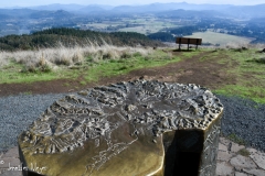 A bronze sculpture shows a relief map.