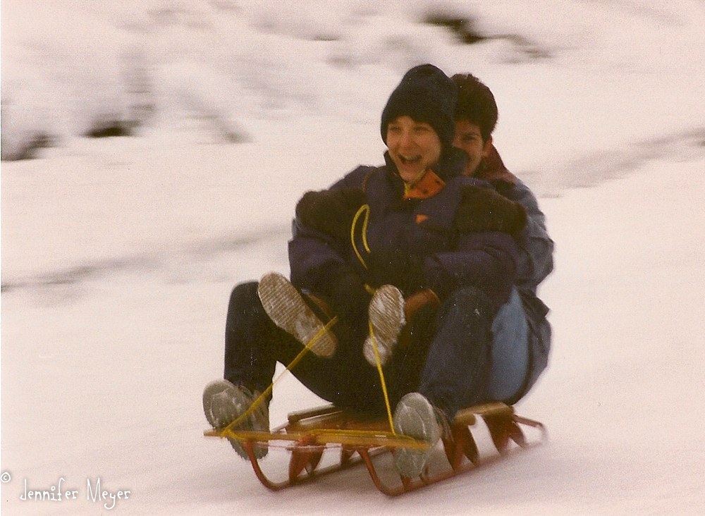 Kathy and me, sledding down our street.