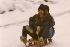 Kathy and me, sledding down our street.