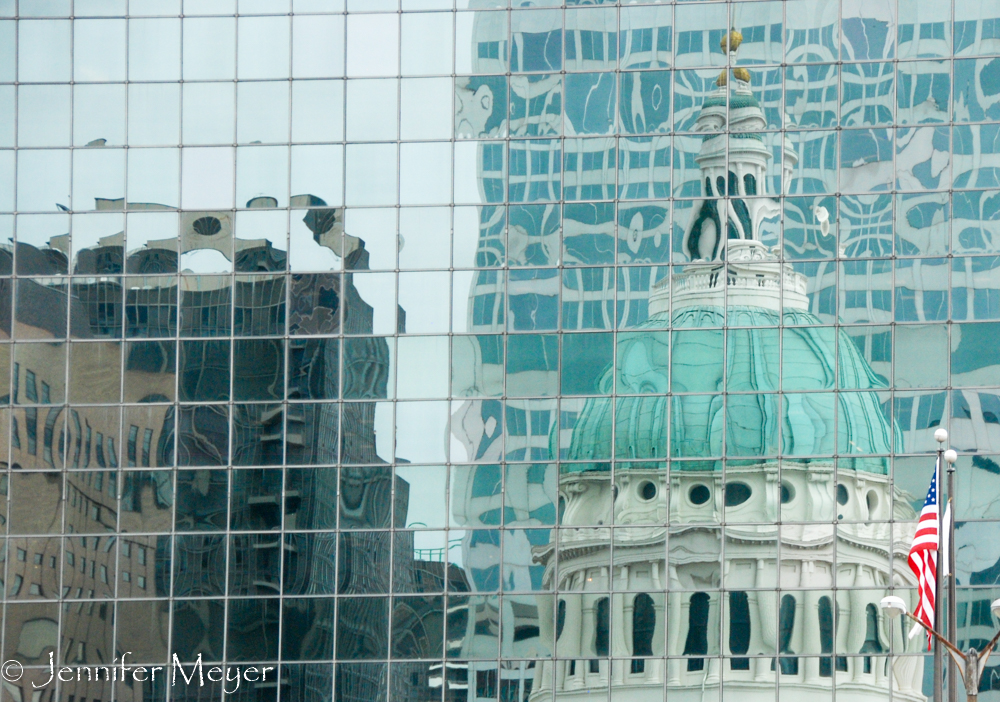 Old capitol reflected in a glass building.