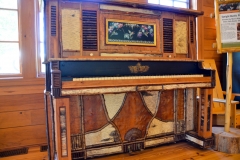 A piano decorated in Adirondack fashion.