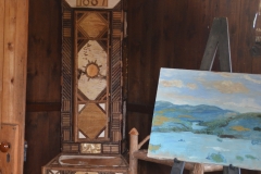 The grandfather clock is decorated with birch and sticks.