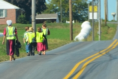 Since they must ride or walk on the road, they wear safety vests.