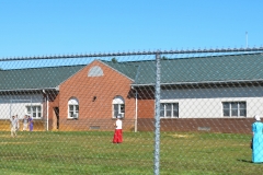 Some kids go to the town high school. Here they play softball.