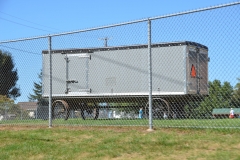 The town high school includes large truck buggies for hauling equipment.