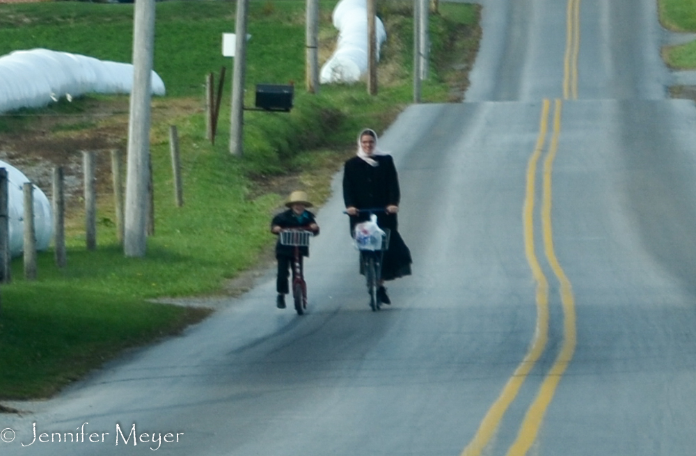 Mom and son, scootering together.