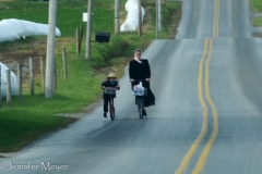 Mom and son, scootering together.