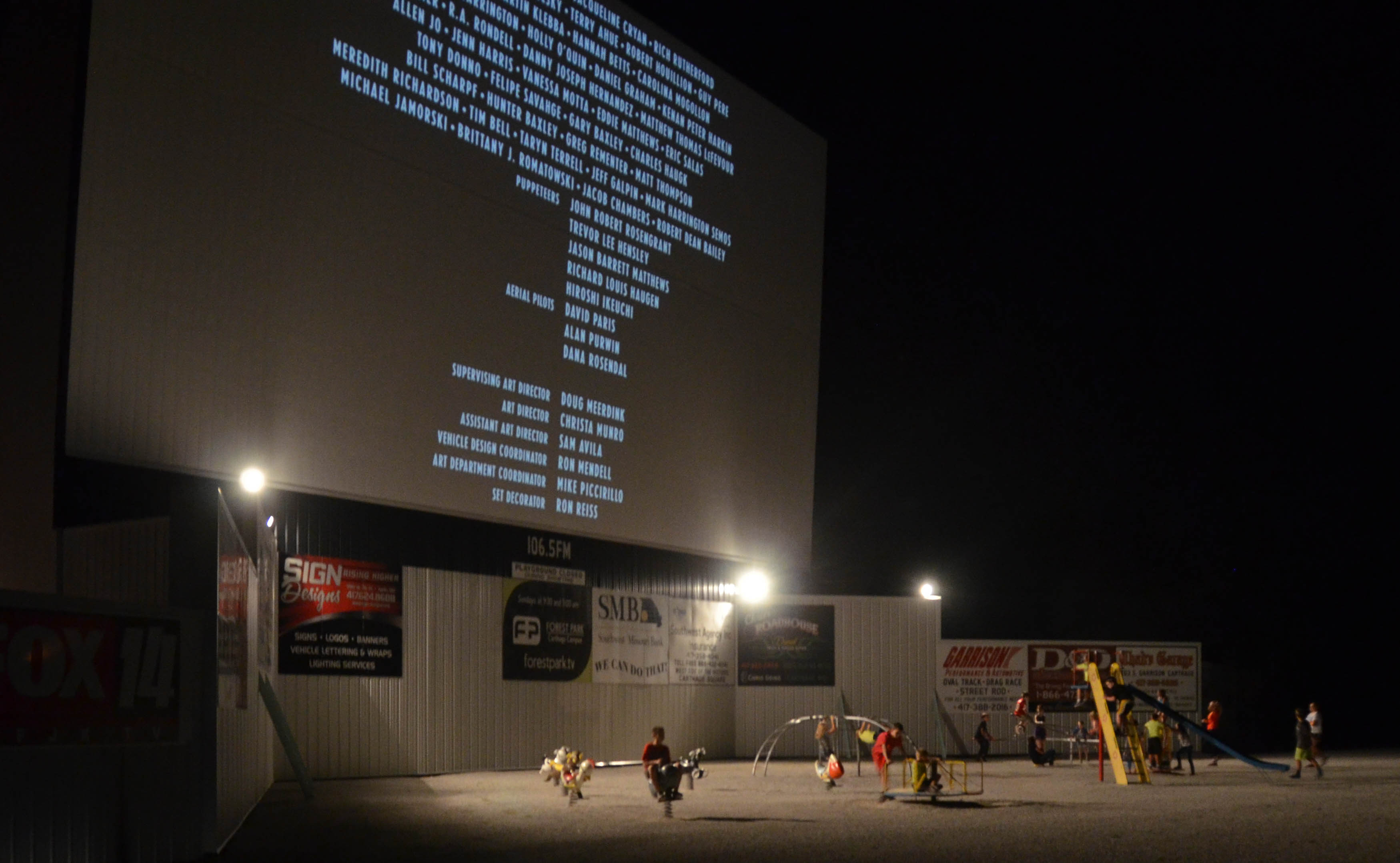 Between movies, kids play under the screen.