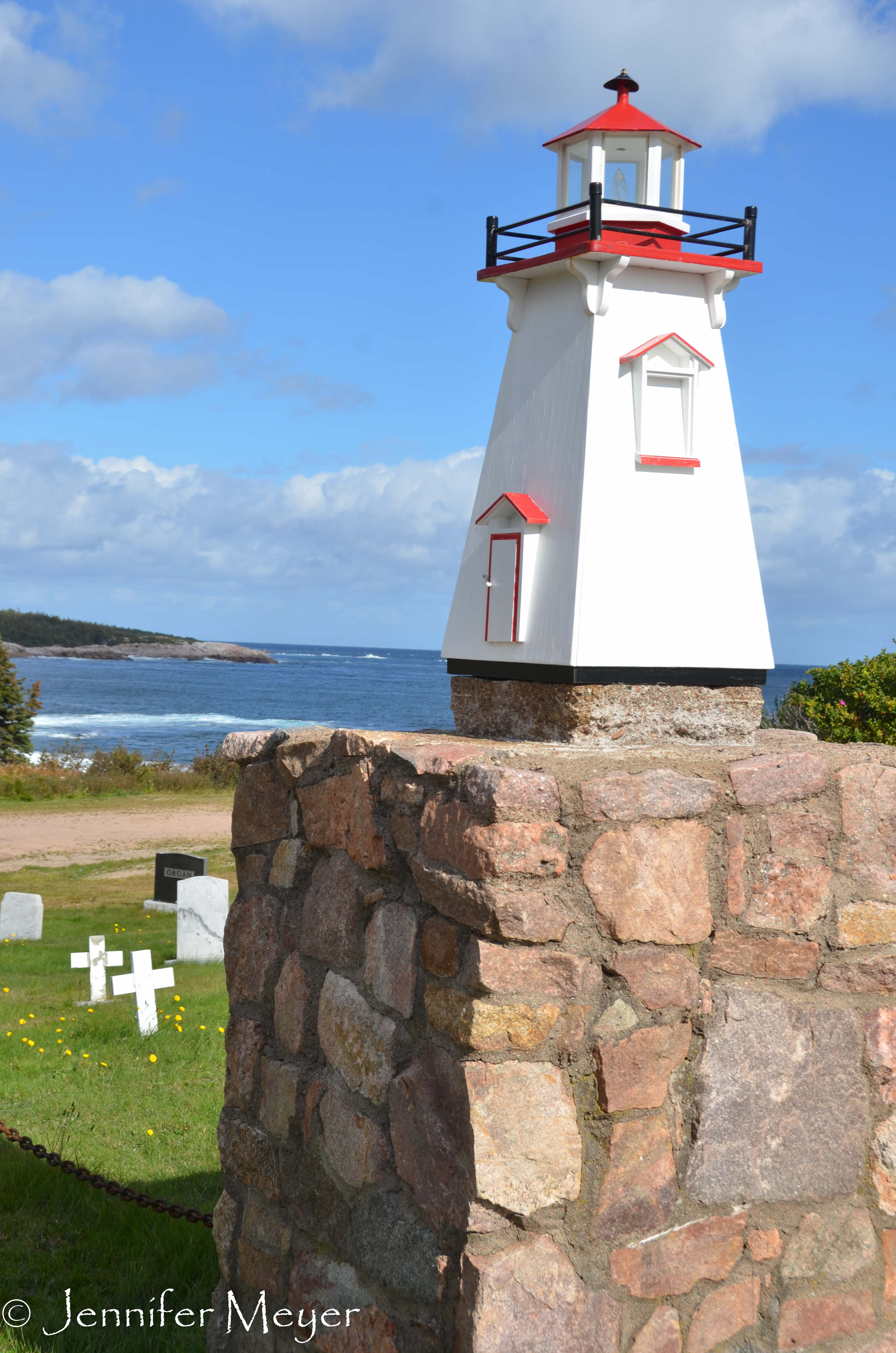 This cemetery by the sea had a little lighthouse.