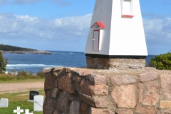 This cemetery by the sea had a little lighthouse.