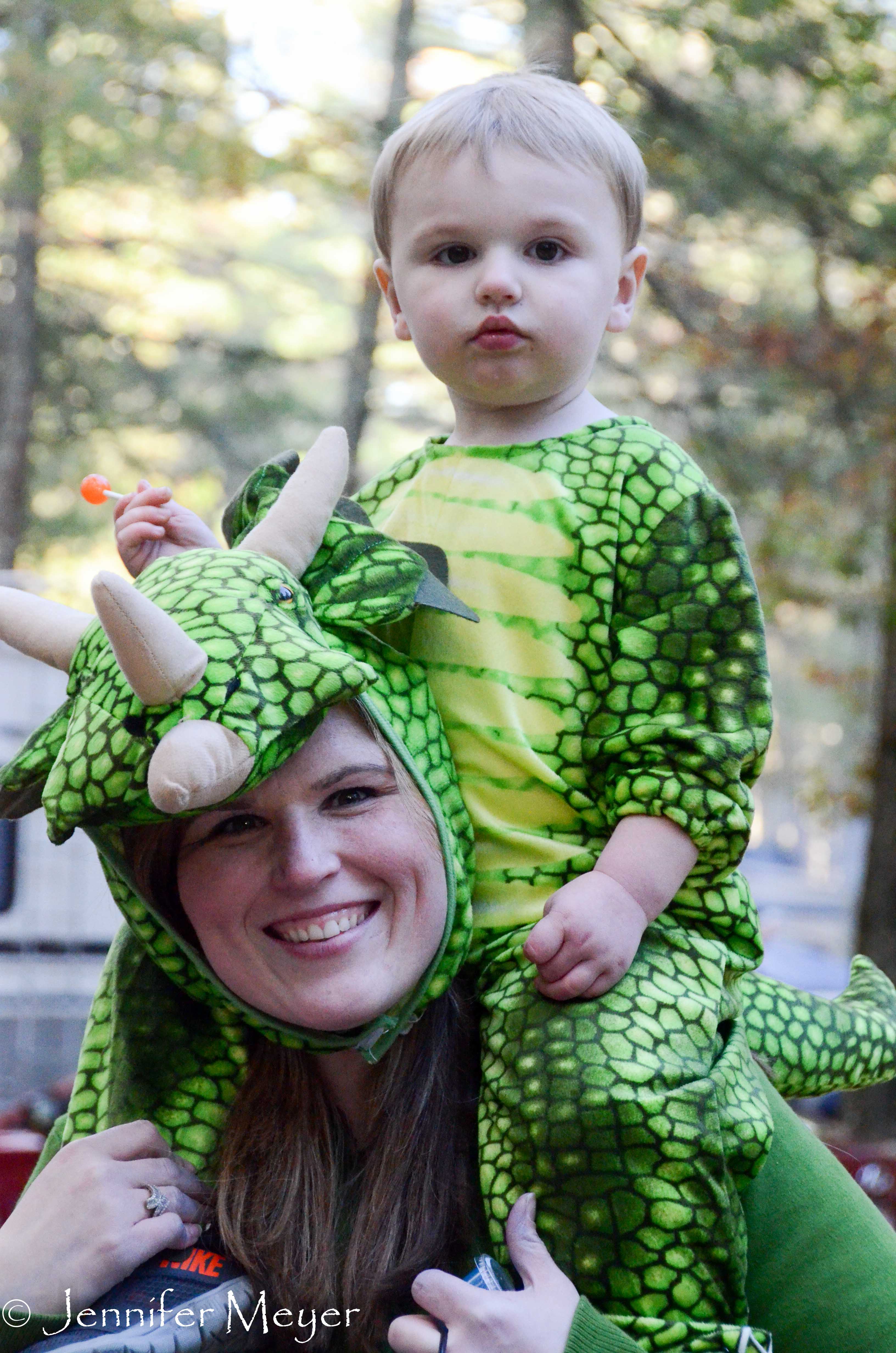 Mom and kid share a dragon costume.