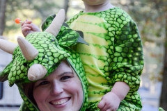 Mom and kid share a dragon costume.