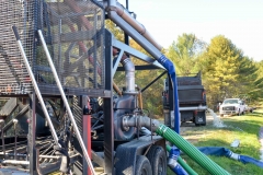 The berries are vacuumed up through this machine and sprayed into trucks.