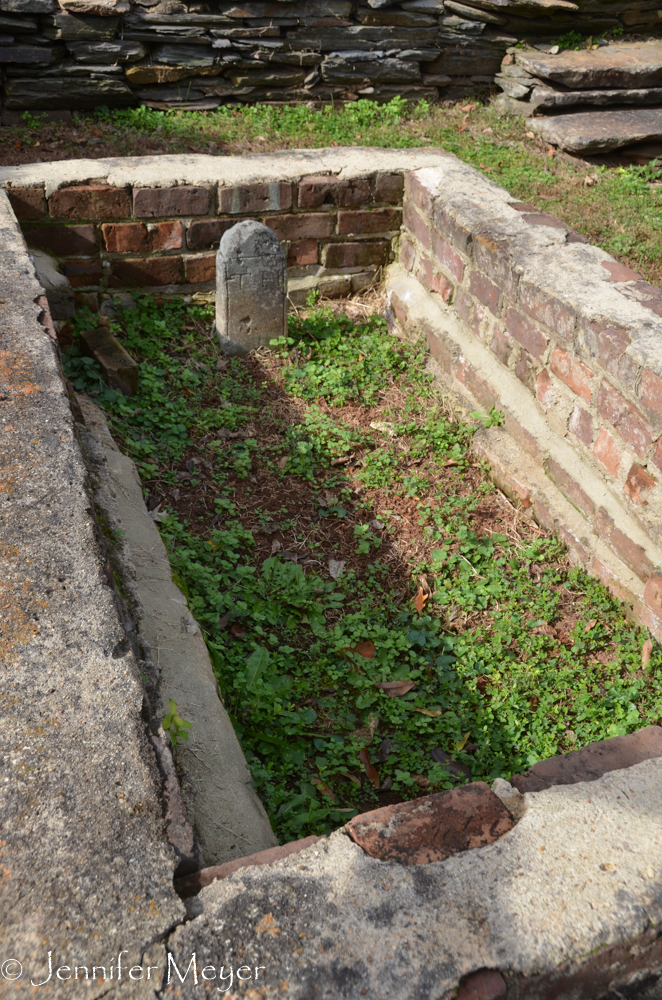 This was an odd little sunken grave, walled off with bricks.