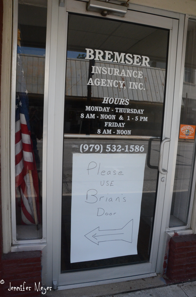 The sign says, "Please use Brian's door."