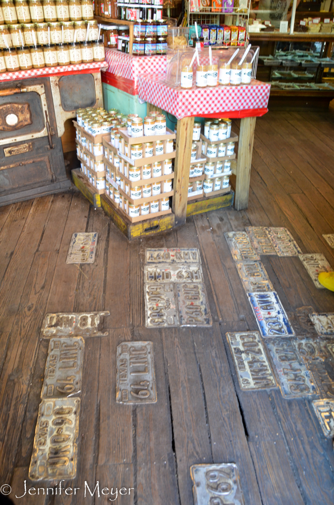 Cracks in the floor are covered with license plates.