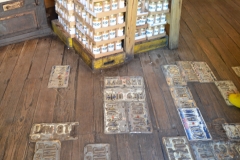 Cracks in the floor are covered with license plates.