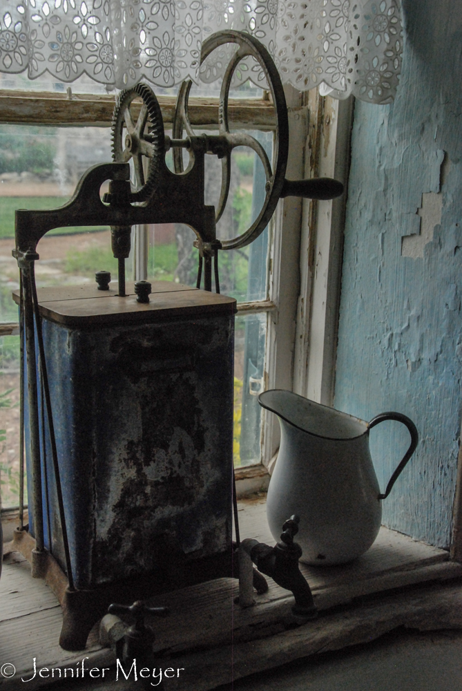 Coffee grinder in a window.
