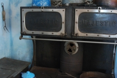Blue kitchen with an iron stove.
