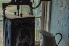 Coffee grinder in a window.