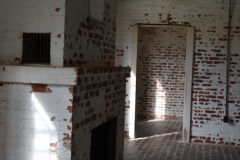 The rooms were all brick and very plain.