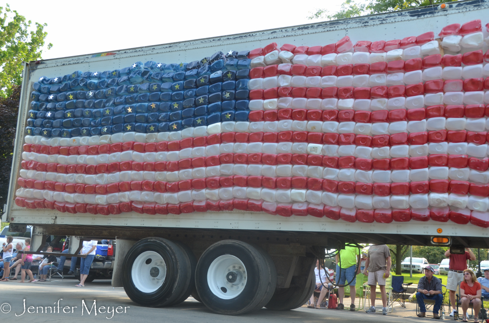 With a flag made of painted milk jugs.
