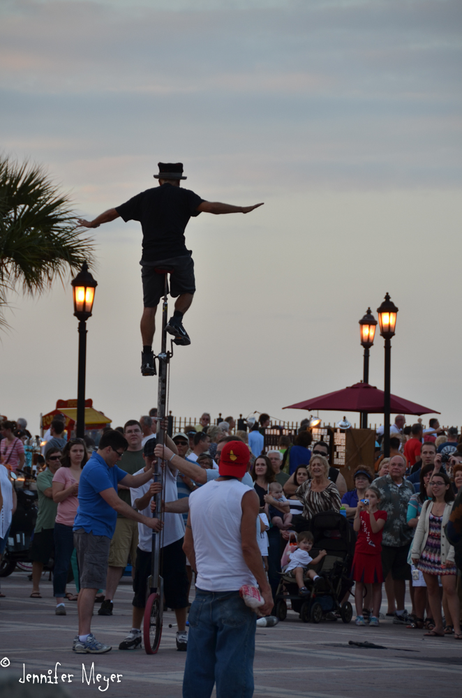Tall unicycle rider.