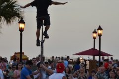 Tall unicycle rider.