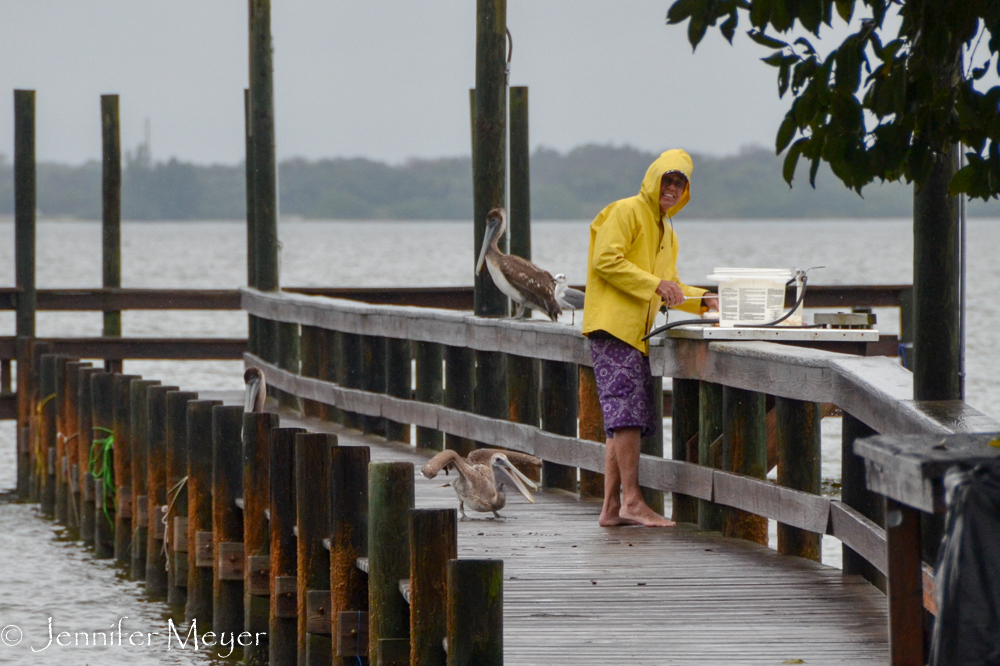 Past a fisherman on a dock.