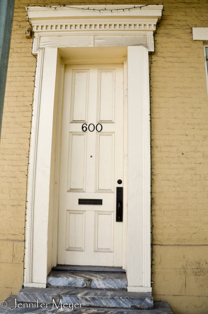 Next to a very tall door.