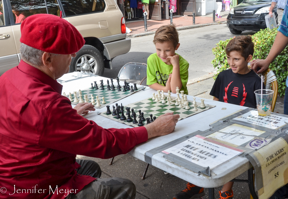 A boy gets a $5 chess lesson.
