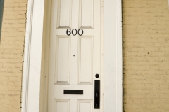 Next to a very tall door.