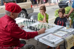 A boy gets a $5 chess lesson.
