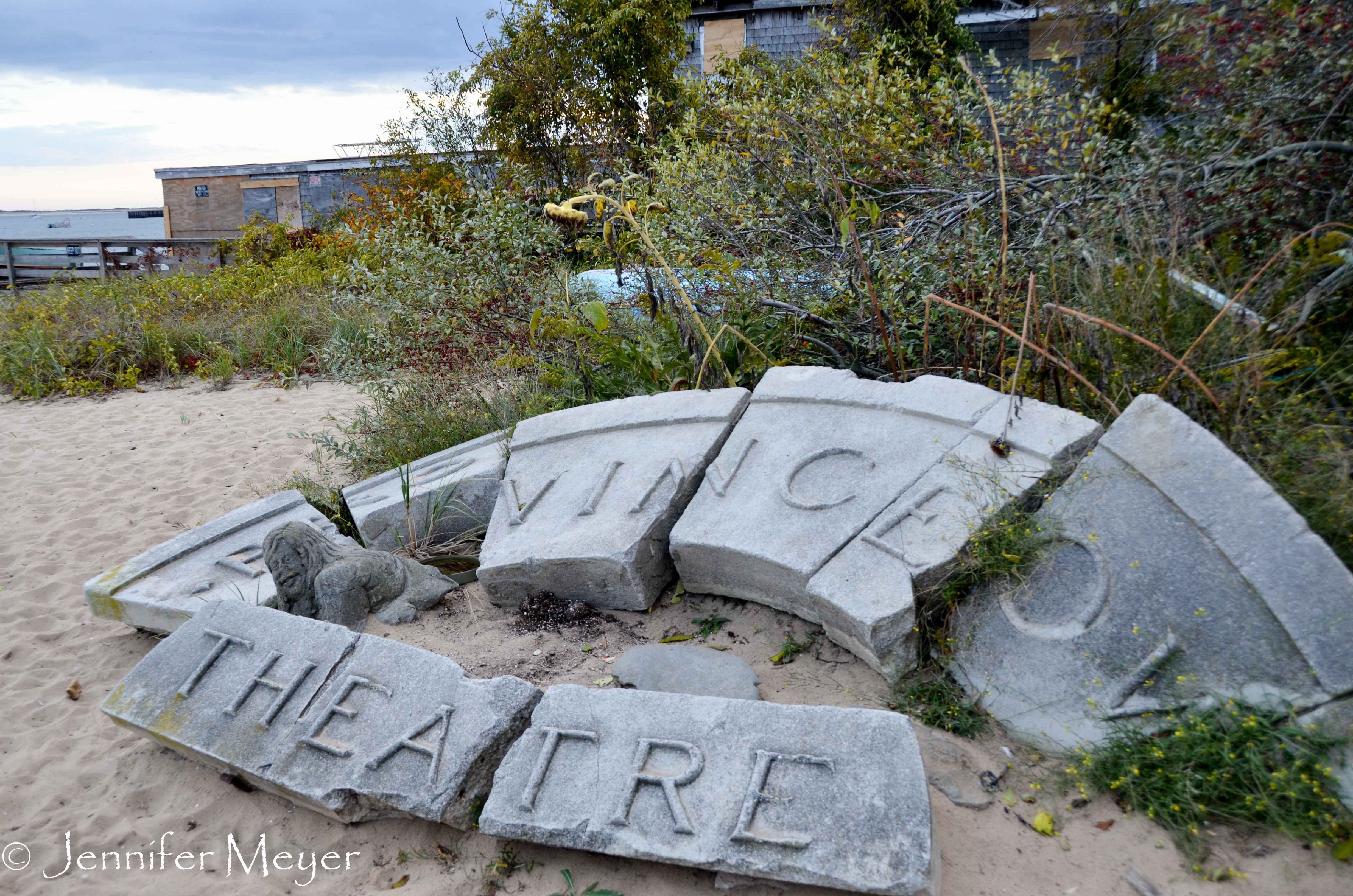 Broken theatre sign on the beach.
