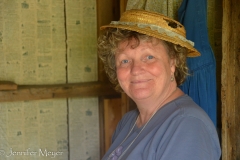 Kate tries on a hat.