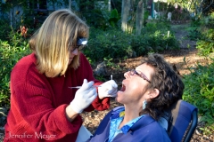 Tammy, a dental hygenist, installs a temporary filling for Julia.