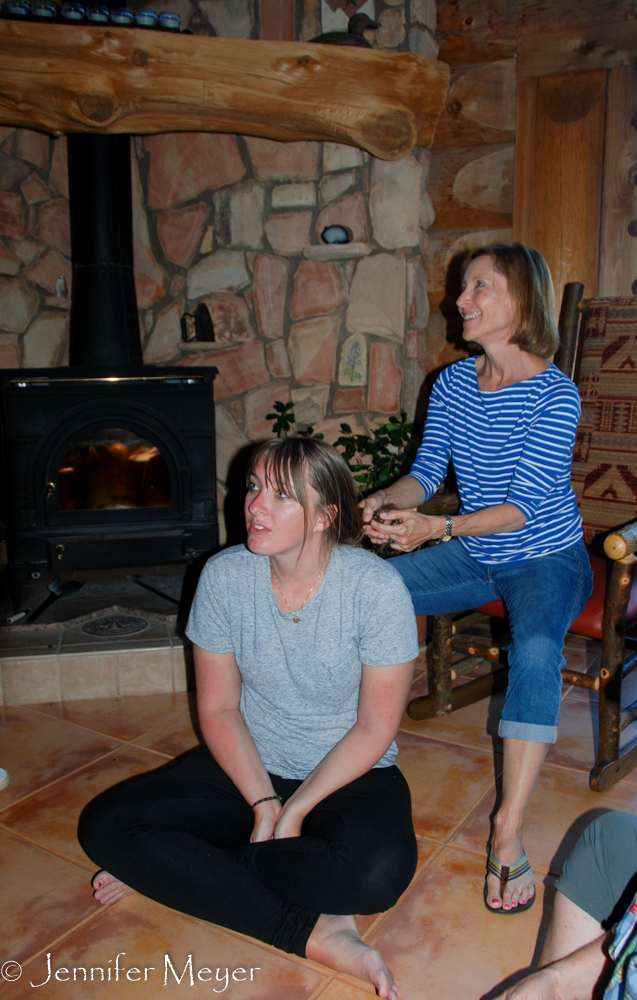 Mom braids Heidi's hair.