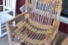 On the porch, a rope and stick rocker.