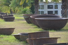 Kettles used to cook down sugar cane. Boiling liquid was poured from large to medium to small kettles.
