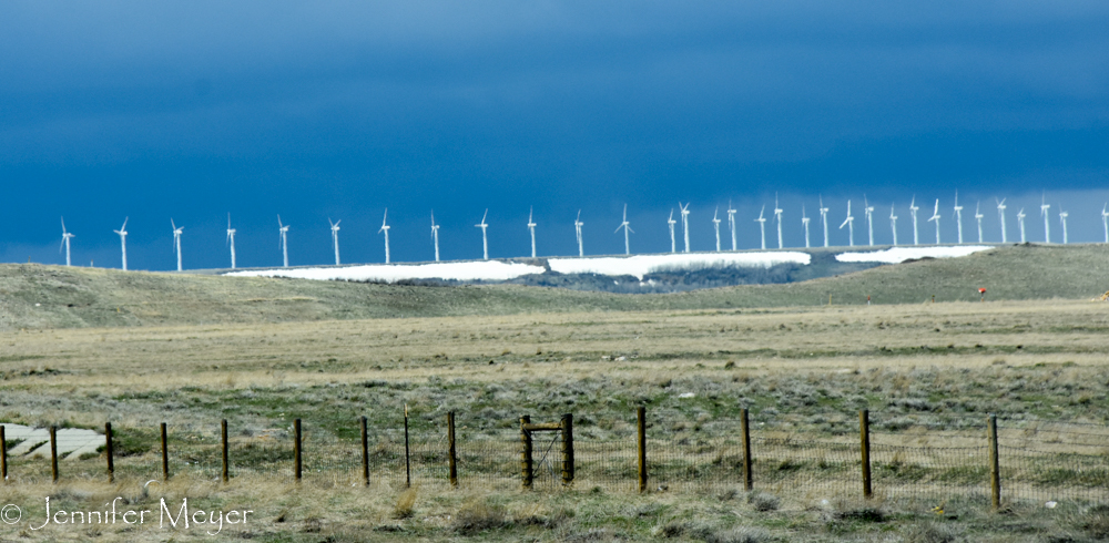 Windmills in a dark sy.