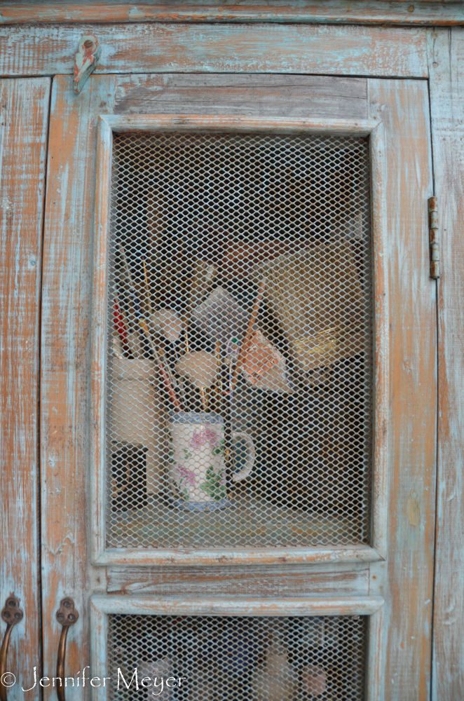Brushes in a pie cabinet.